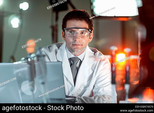 Portrait of a confident male engineer in his working environment. Science and technology concept