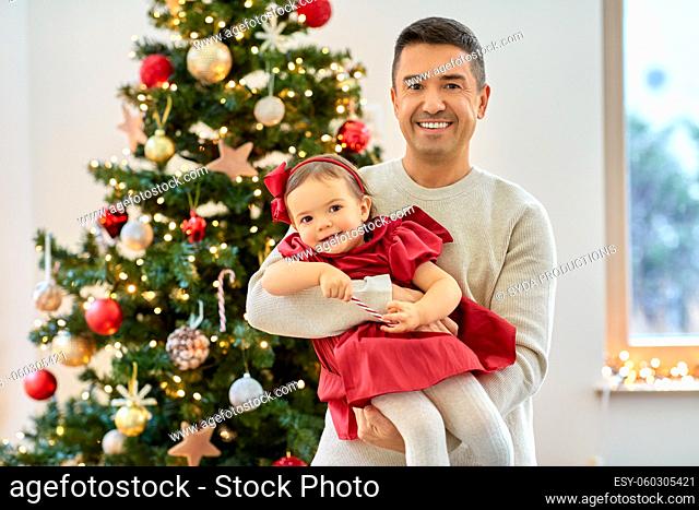 happy father and baby girl over christmas tree