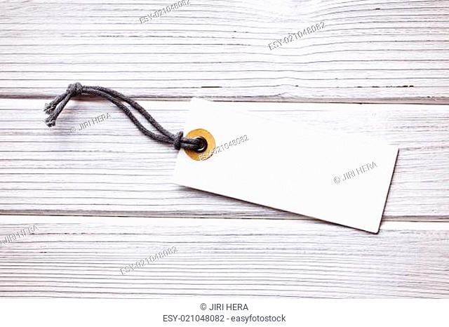 blank price tag label on wooden background