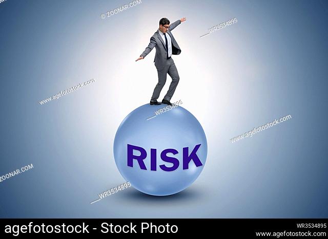 Young businessman in business risk and uncertainty concept