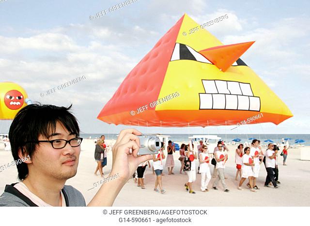 ArtCenter South Florida benefit, Asian male. Skywalkers Giant Blimp Parade. Atlantic Shore. Miami Beach. Florida. USA