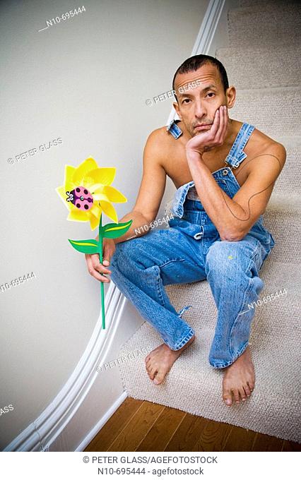 Hispanic man holding a plastic spinning flower