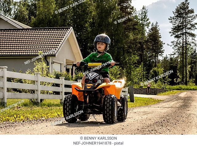 Boy on four-wheeler, Orebro, Sweden