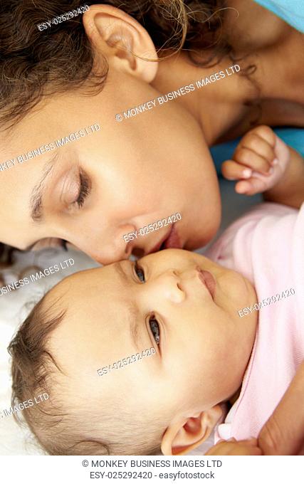 Mother Playing With Baby Daughter At Home