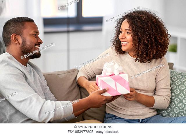 happy couple with gift at home
