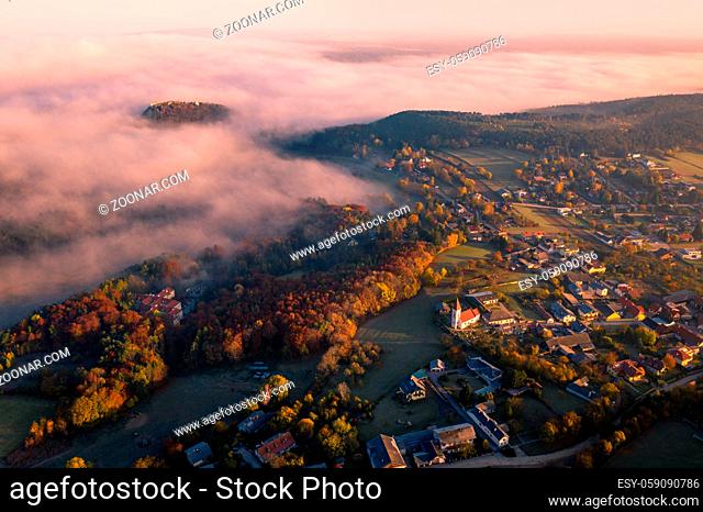Small town village during the sunrise with fog. surrounded by hills in lower austria. Aerial drone photo in autumn