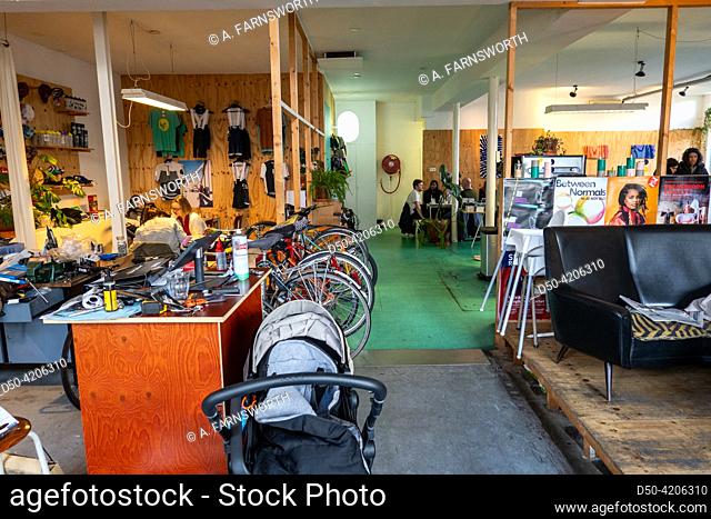 Rotterdam, Netherlands, Young and hip patrons inside a popular bike cafe in the Oude Noorden district where you can do bike repairs with a coffee