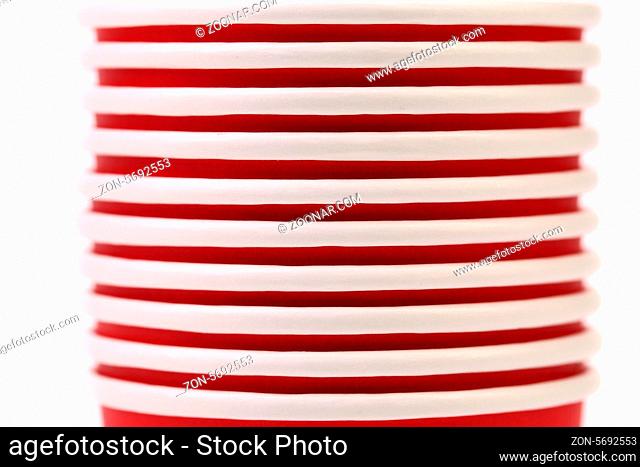 Pile of colorful paper coffee cup. Close up. White background