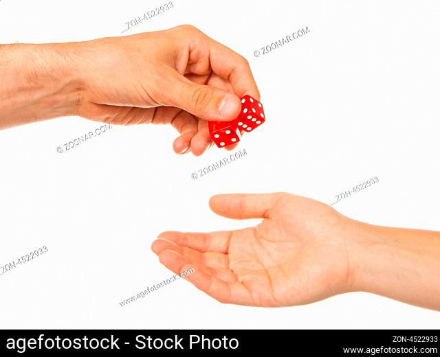 Two red dice being given, man to woman