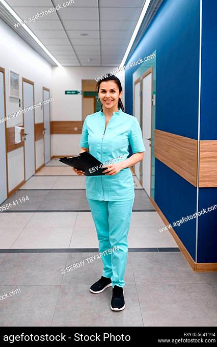 Smiling female doctor poses in clinic. Doctor in uniform, medical worker, medicine and health, professional healthcare in hospital