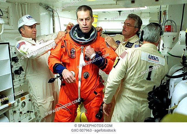 03/08/2001 --- In the White Room, Launch Pad 39B, STS-102 Commander James Wetherbee gets help with final suit preparations before entering Space Shuttle...