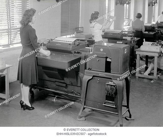 A woman operates one of 12 IBM computers in use during the 1940 Census. The units were Alphabetic Accounting Machine Equipped with Gang Summary Punch made by...