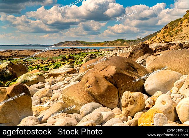 Stones and clouds at Osmington Bay, Osmington Mills, near Weymouth, Jurassic Coast, Dorset, UK