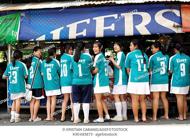 Girls from a local sports club getting their lunch at a food stall, Bangkok, Thailand, Southeast Asia