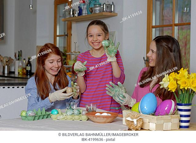 Girls colouring Easter eggs for Easter, Upper Bavaria, Bavaria, Germany