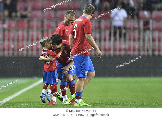 Tomas Rosicky and his son Tomas Rosicky Jr and father Jiri, left, and brother Jiri Jr, right, of Czech team enter the pitch in the match
