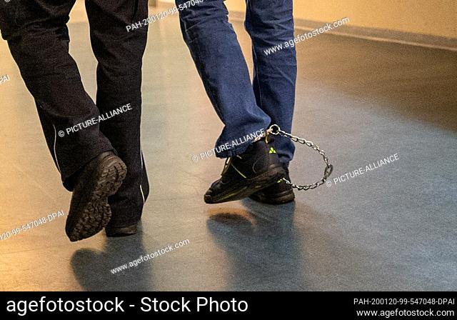 20 January 2020, Baden-Wuerttemberg, Freiburg: Christian L. is wearing leg irons while being led out of the courtroom of the Regional Court at the beginning of...