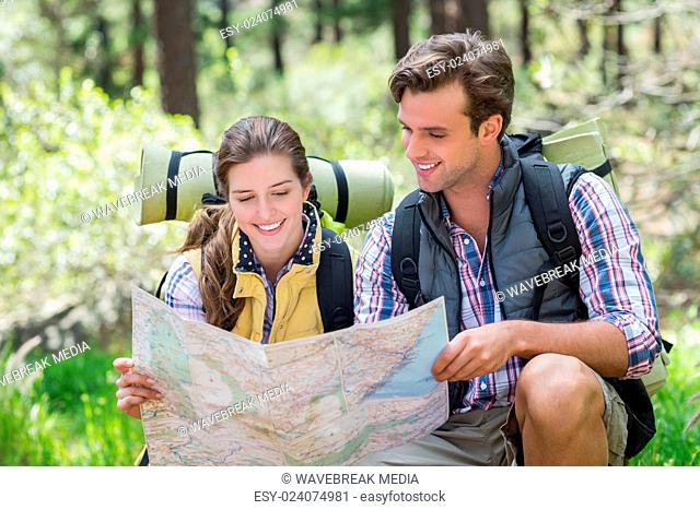 Young couple discussing while looking at map