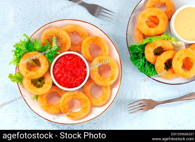 Calamari rings. Squid rings with salad and various dips, overhead shot