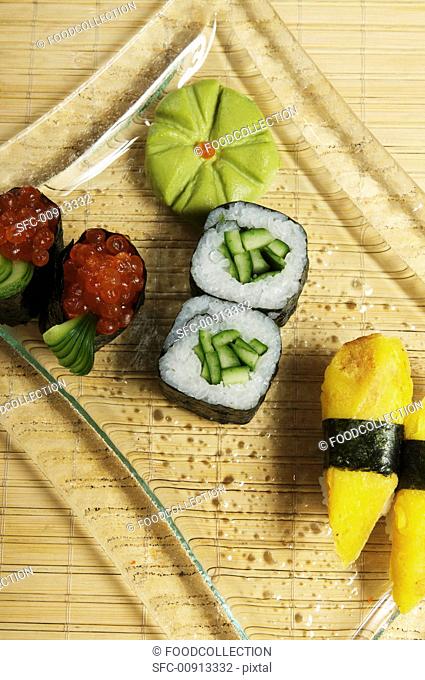 A sushi platter maki with cucumber and salmon caviar, nigiri with royale