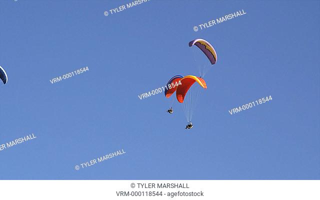WS People paragliding mid-air / Lehi, Utah, USA