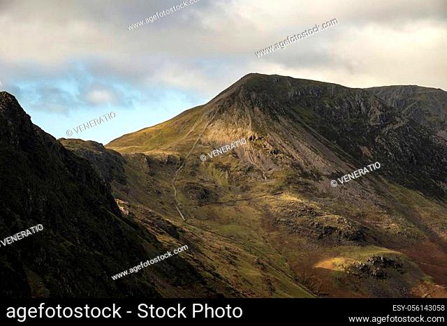Majestic Autumn Fall landscape image of mountain peaks in Lake District near Buttermere with gorgeous light across ridge