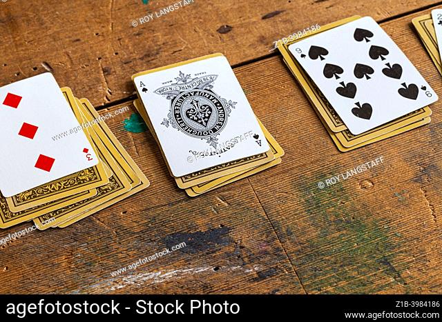 Playing cards on a rustic pioneer table at the Britannia Ship Yard in Steveston British columbia Canada