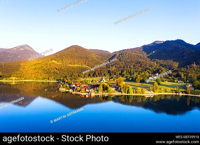 Germany, Bavaria, Kochel am See, Drone view of village on shore of Lake Walchen at springtime dawn
