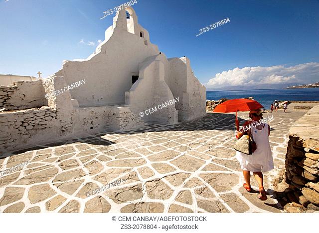 Woman with a umbrella near the Paraportiani church, Mykonos, Cyclades Islands, Greek Islands, Greece, Europe