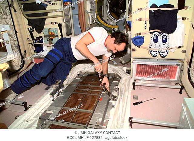 Cosmonaut Yury V. Usachev, Expedition Two commander representing Rosaviakosmos, conducts maintenance on the Treadmill Vibration Isolation System (TVIS) in the...