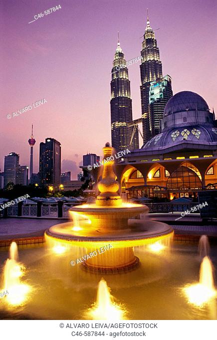 Petronas twin towers (the tallest building in the world), Asy-Syakirin Mosque in the KLCC Park in foreground. Kuala Lumpur. Malaysia