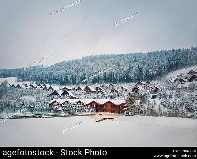 Bukovel ski resort, town cabin hotels covered with snow in a cold winter day. Holiday and vacation destination in the Ukrainian Carpathian mountains