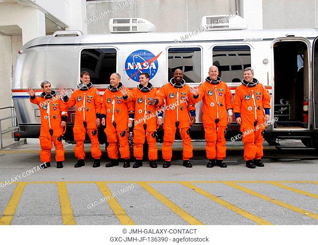 After suiting up, the STS-122 crewmembers pause alongside the Astrovan to wave farewell to onlookers before heading for launch pad 39A for the launch of Space...