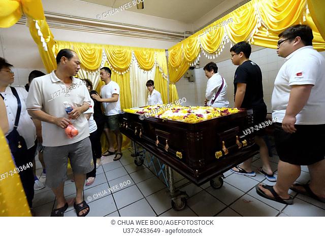 Relatives strolling in circle and prayers for the deceased. Sarawakian chinese funeral ceremony. Malaysia