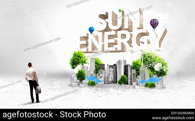 Rear view of a businessman standing in front of SUN ENERGY inscription, Environmental protection concept