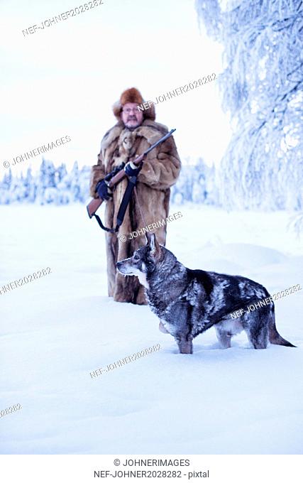 Mature man walking dog at winter