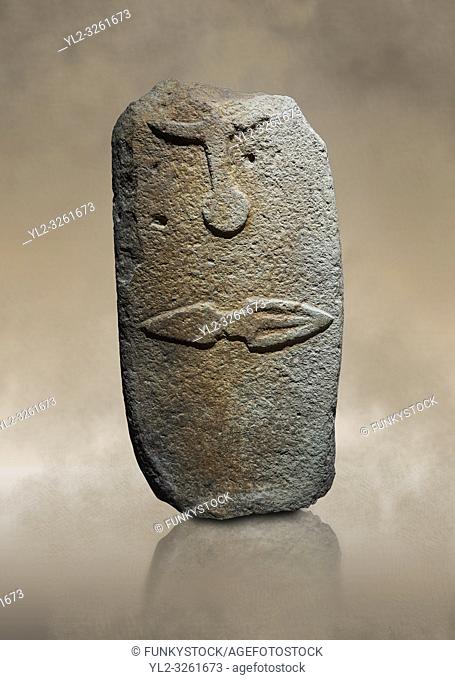 Late European Neolithic prehistoric Menhir standing stone with carvings on its face side. The representation of a stylalised male figure starts at the top with...