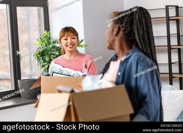 women with boxes moving to new home