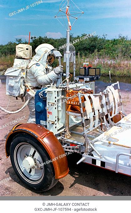 Scientist-astronaut Harrison H. Schmitt, lunar module pilot of the Apollo 17 lunar landing mission, procures a geological hand tool from the tool carrier at the...