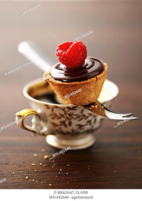 A raspberry chocolate cake topped with a fresh raspberry