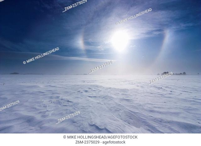 Arctic air and wind driven snow and ice create vivid sun dogs and haloing over western Iowa