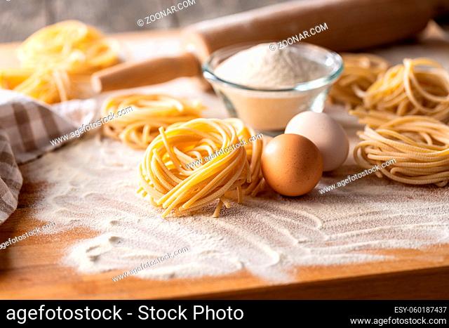 Italian pasta nest. Uncooked spaghetti nest and flour