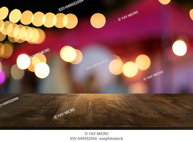 Empty wooden table in front of abstract blurred background of coffee shop . can be used for display or montage your products