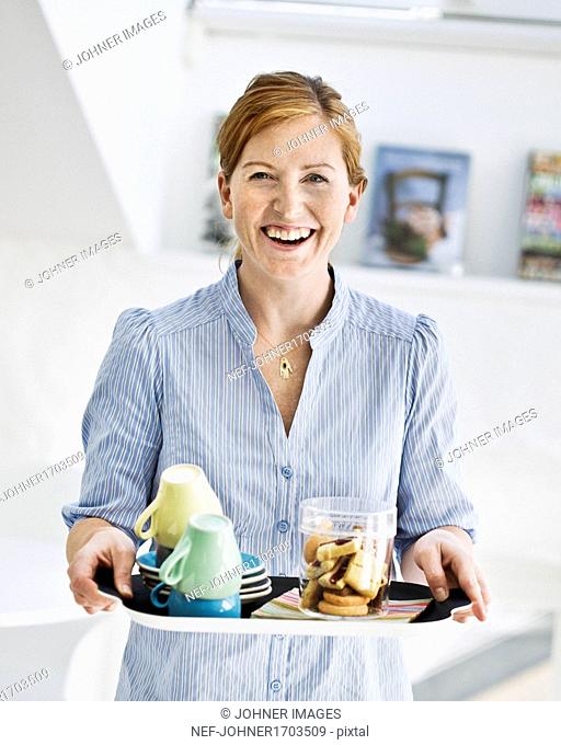 Smiling woman with tray