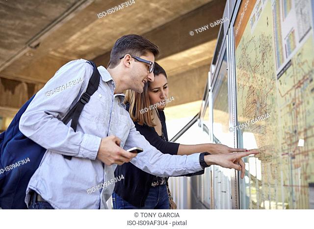 Couple looking at subway map, Los Angeles, California, USA