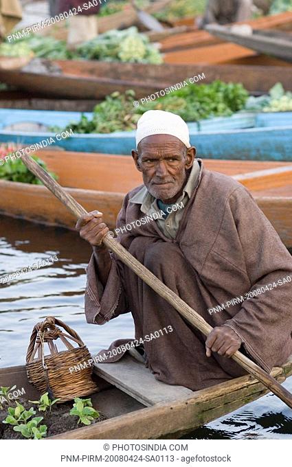 Man selling plants in a boat, Dal Lake, Srinagar, Jammu And Kashmir, India