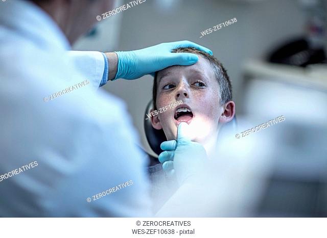 Boy with braces in dental surgery opening his mouth