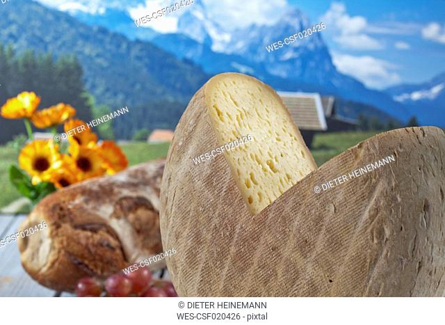 Bethmale cheese in front of mountains, digital composite
