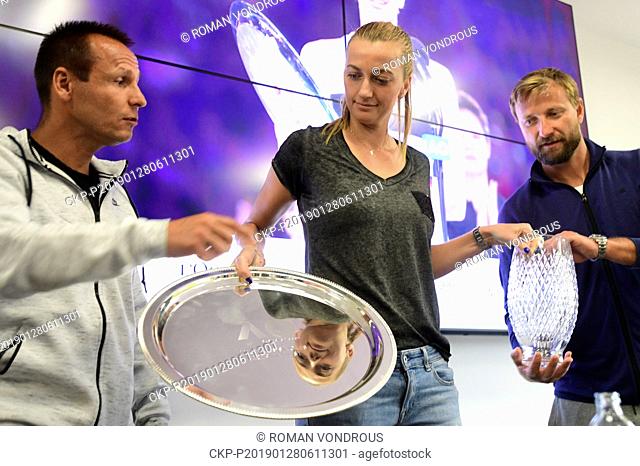 Czech tennis player Petr Kvitova (center) shows the silver plate trophy during a press conference after her return of the Australian Open, on January 28, 2019