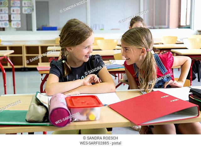 Two schoolgirls at class